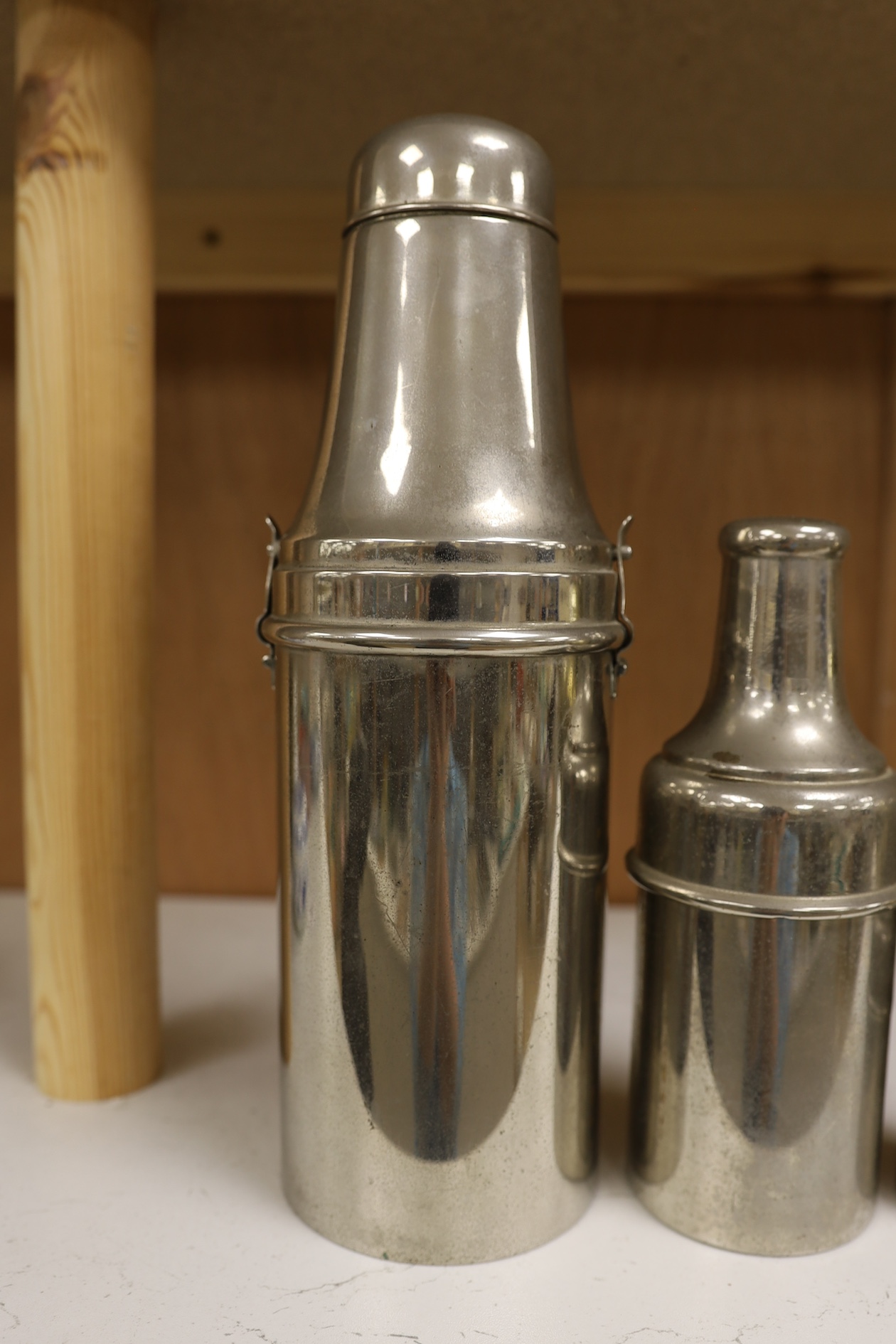 A 1920's chrome plated travelling cocktail flask set and two similar cased bottles, tallest 28.5cm high. Condition - fair